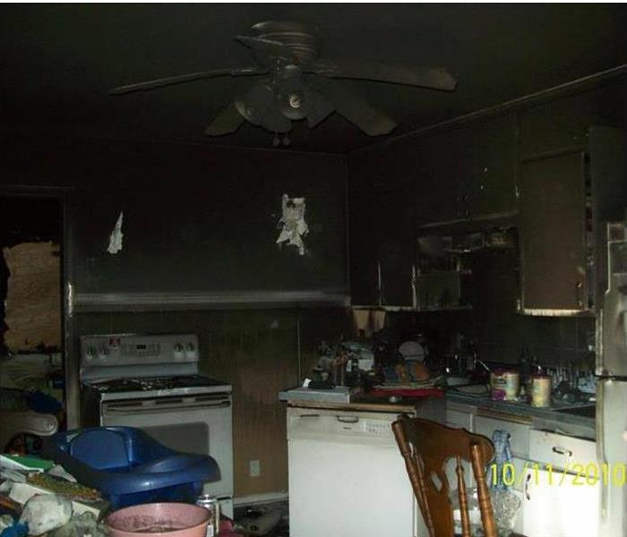 devasted, black and burned kitchen and appliance