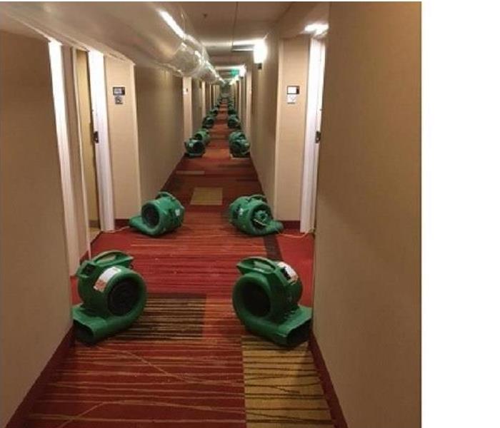 rows of air movers--green in a hallway, about 35 feet running