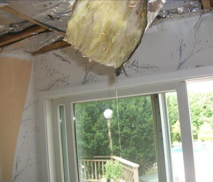 Damaged ceiling with insulation showing 