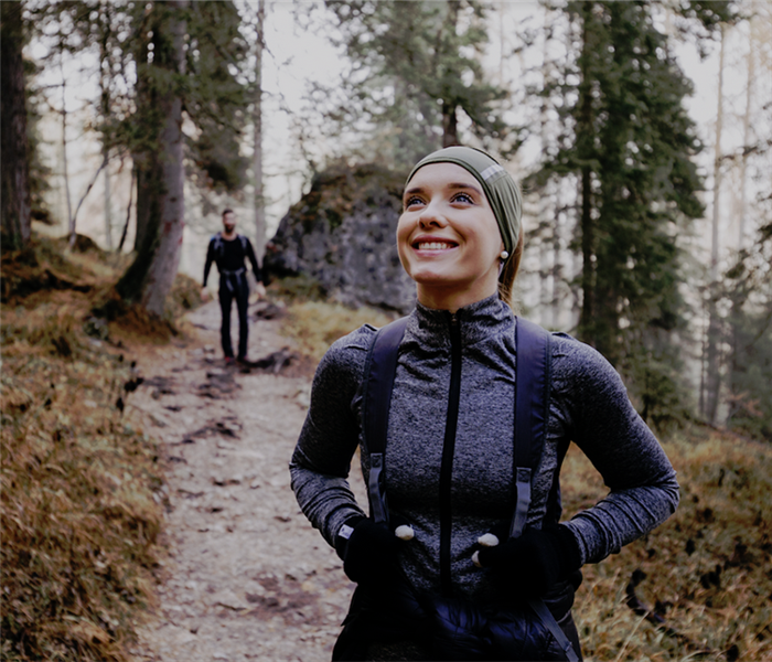 a man and a woman hiking on a trail